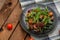 Fresh salad with arugula, shrimp, cherry tomato and avocado. Wooden background. Close-up. Top view