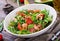 Fresh salad bowl with shrimp, tomato, avocado and arugula