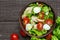 Fresh salad caesar with chicken, quail eggs, tomatoes and lettuce in a bowl