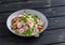 Fresh salad with cous cous, vegetables and baked salmon. Healthy tasty food.