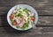 Fresh salad with cous cous, vegetables and baked salmon. Healthy tasty food.