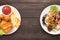 Fresh salad and Fried chicken and french fries on the wooden background. contrasting food