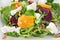 Fresh salad with roasted beetroot, white cheese, orange, nuts