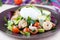 Fresh salad with shrimps, tomatoes, herbs, avocado, poached egg