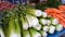 Fresh salad vegetables on long counter, wholesale market trade, healthy food