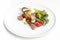 Fresh salad on a white plate, meat, cabbage, tomatoes, egg. Food photography on a white background