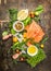 Fresh salmon fillet with fresh healthy herbs,vegetables, oil and spices on rustic wooden background