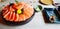 Fresh salmon sliced on black bowl, wasabi in small green plate and Fried salmon belly on wooden table and at Japanese restaurant