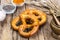 Fresh salty German bread: pretzels on a background of old boards