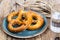 Fresh salty German bread: pretzels on a background of old boards