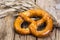 Fresh salty German bread: pretzels on a background of old boards