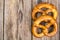 Fresh salty German bread: pretzels on a background of old boards