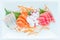 Fresh sashimi set served on white Japanese style plate.