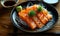 Fresh Sashimi-Style Salmon Slices Served on a Black Plate with Garnish and Soy Sauce on a Wooden Table, Traditional Japanese