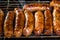 Fresh sausage and hot dogs grilling