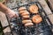 Fresh sausage and hot dogs grilling outdoors