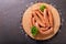 Fresh sausages on a chopping board, top view