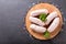 Fresh sausages on a chopping board, top view