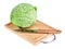 Fresh savoy cabbage with knife on chopping board