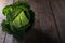 Fresh savoy cabbage from organic grower farm on rustic wooden table, antioxidant food, healthy eating and diet concept