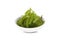 Fresh sea grapes, green caviar, Umi-budou seaweed in white small bowl on white background