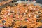 Fresh seafood penne tomato pasta cooking in large wok pan during hotel brunch buffet outside