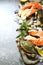 Fresh seafood: salmon steak, crabs and shrimps on stone background
