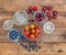 Fresh seasonal fruits in jars / blueberries, strawberries and cherries on a wooden table