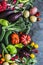 Fresh seasonal vegetables food background. Aubergines, tomatoes, radishes, peppers, broccoli, potatoes, beets on a dark background