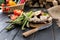 Fresh seasonal vegetables and halved apple on wooden table top