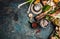 Fresh seasoning and vegetarian organic cooking ingredients for tasty cooking on dark rustic background, top view, place for text.