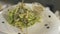 Fresh seaweed salad on white dish, slow motion