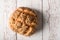 Fresh seedy bread on white wooden background