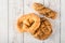 Fresh seedy breads on white wooden background