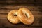 Fresh sesame seed bagel bread, isolated on a vintage wooden table