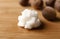 Fresh shea butter on wooden table, closeup.