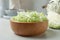 Fresh shredded cabbage on light table, closeup