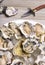 Fresh shucked oysters plate over wood background