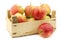 Fresh `Sissi red` apples in a wooden crate