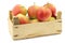 Fresh `Sissi red` apples in a wooden crate