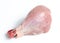 Fresh skinless chicken drumstick leg against white