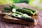 Fresh and sliced cucumbers. Sliced cucumbers on a cutting board.