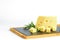 Fresh sliced emmental cheese with rosemary on the kitchen cutting board. Healthy food with calcium