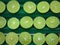 Fresh sliced green lemons or lime. Ripe juicy lemonade background.