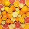 Fresh sliced, halved and whole citrus fruits as closed fruit background