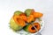 Fresh sliced mangoes fruits served on a plate isolated on white background, fresh mango fruit