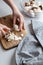 Fresh sliced mushrooms at wooden cutting board. Woman chopping food ingredients.