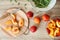 Fresh sliced peaches with wooden board on table