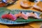 Fresh sliced raw tuna or otoro, chutoro and akami sushi sashimi served with pickled wasabi. Japanese traditional food.