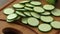 Fresh sliced zucchini on cutting board, on wooden background